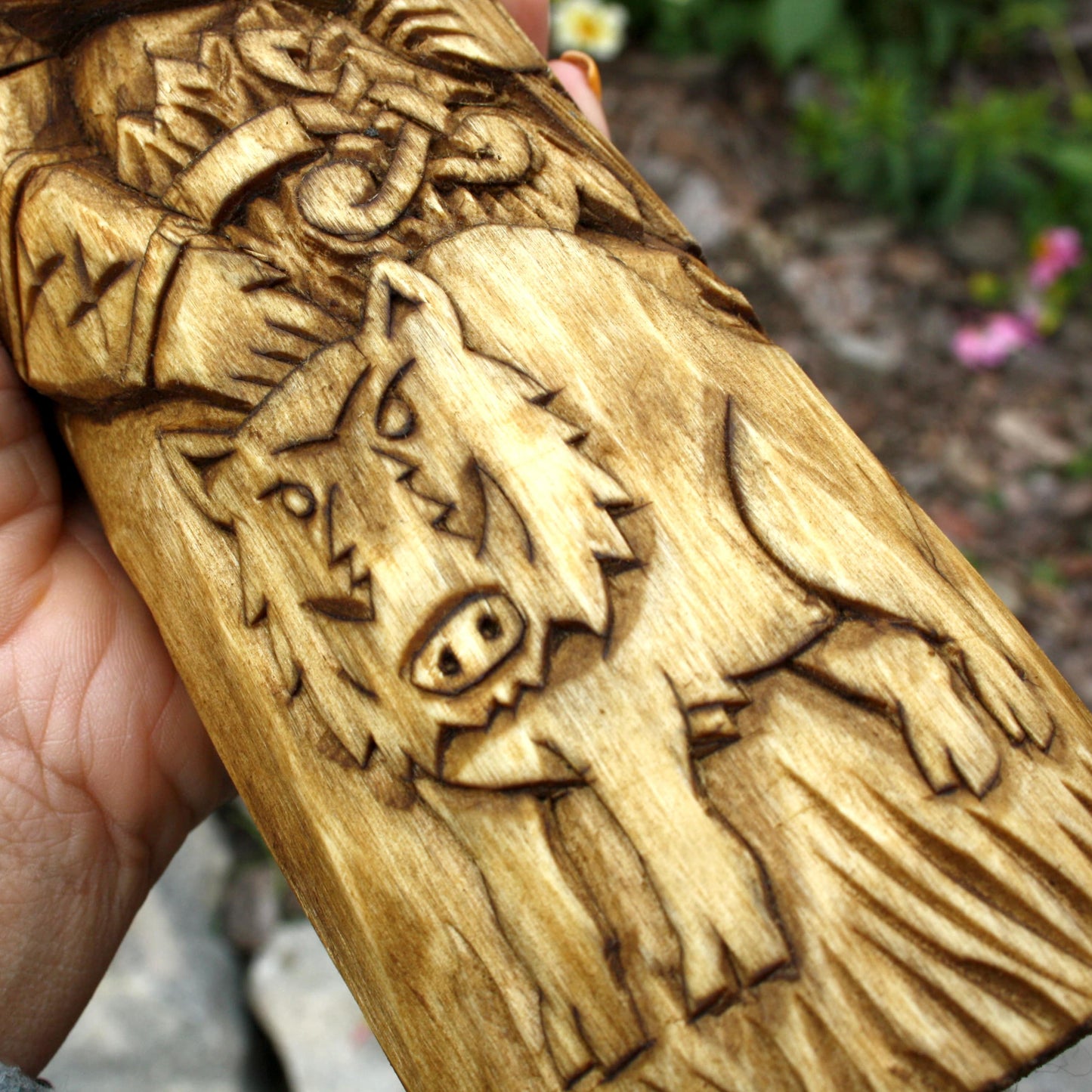 Freyr with boar detailed wood carving close up