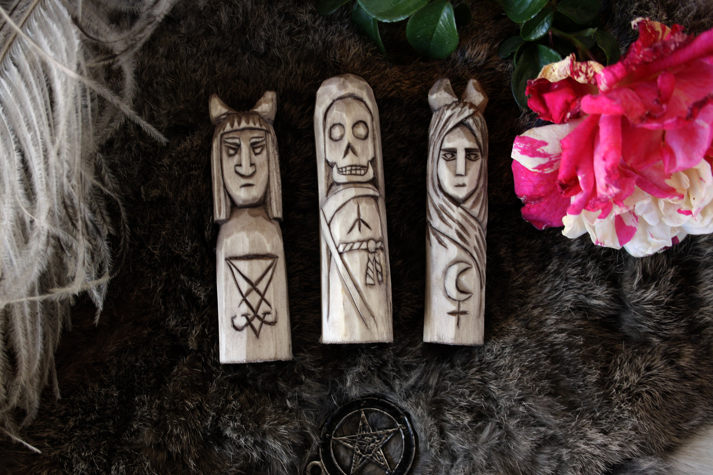 Small handcorved wooden figurines of Death Lilith and Lucifer.