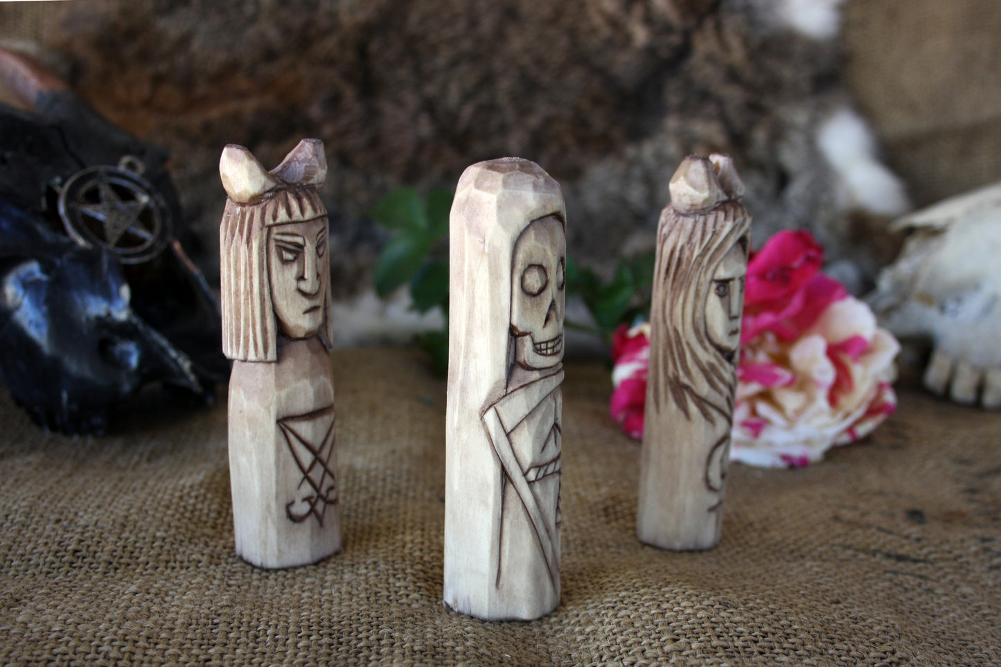 Small handcorved wooden figurines of Death Lilith and Lucifer.