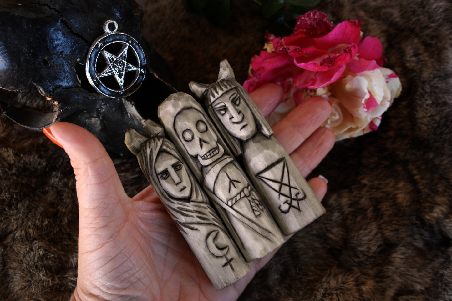 Small handcorved wooden figurines of Death Lilith and Lucifer.
