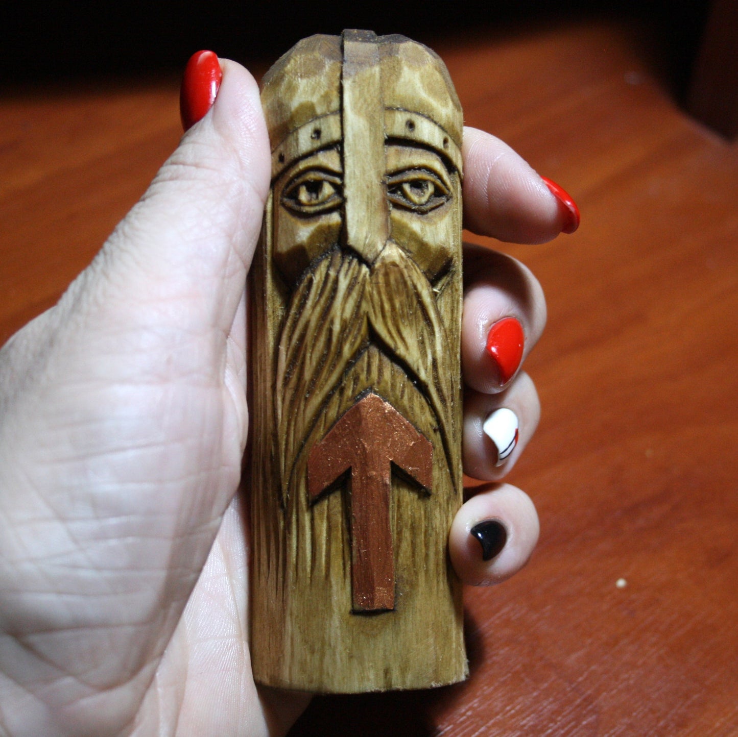 Tyr wooden plaque held in hand showing size