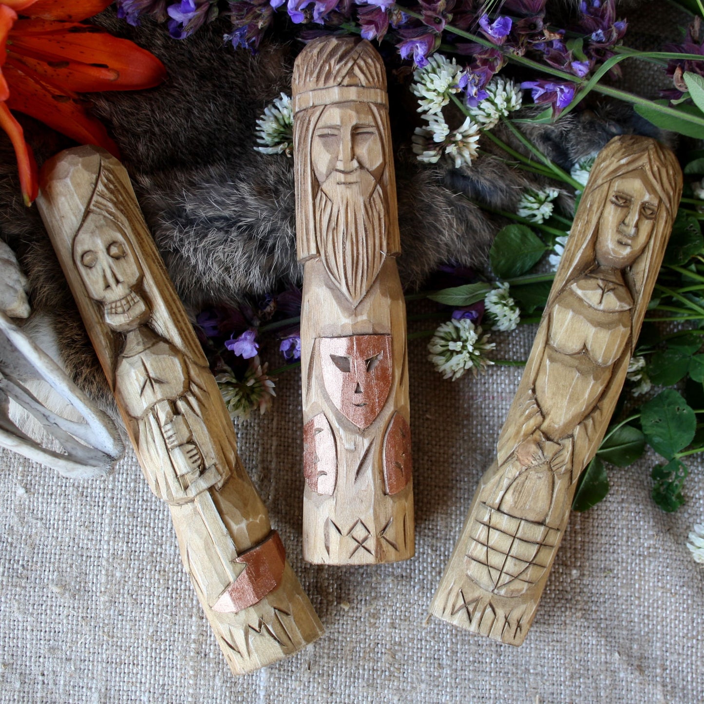 Idunna wooden statue 18 cm hand carved figurine with other Norse Goddesses on a textured surface with flowers and fur.