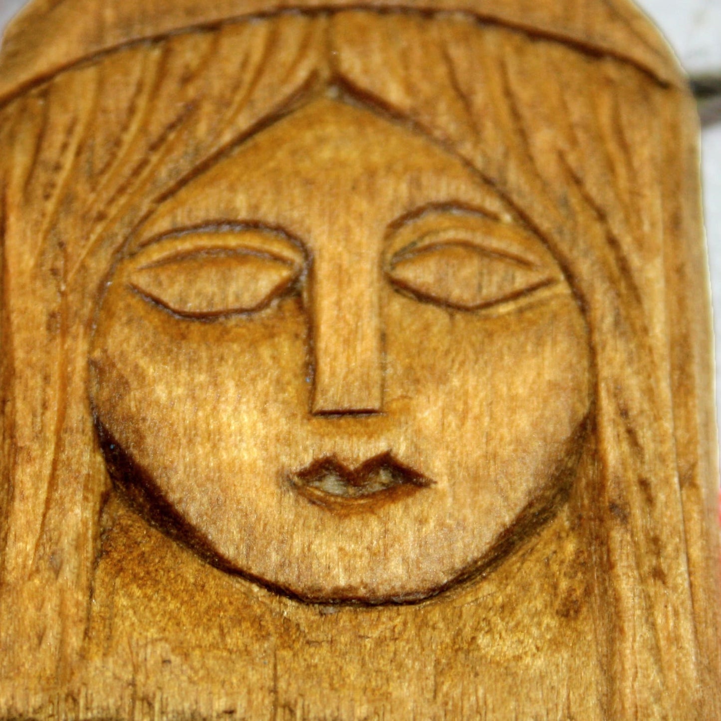 Close-up of handmade Lada wooden amulet with carved details