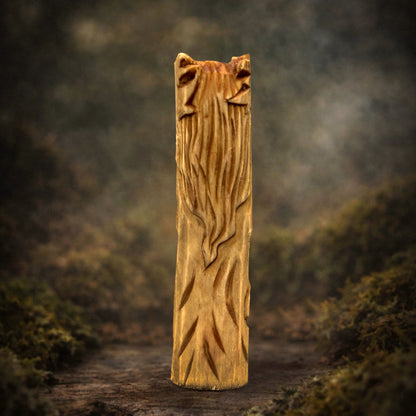 Side view of wooden Cernunnos figurine showing carving texture