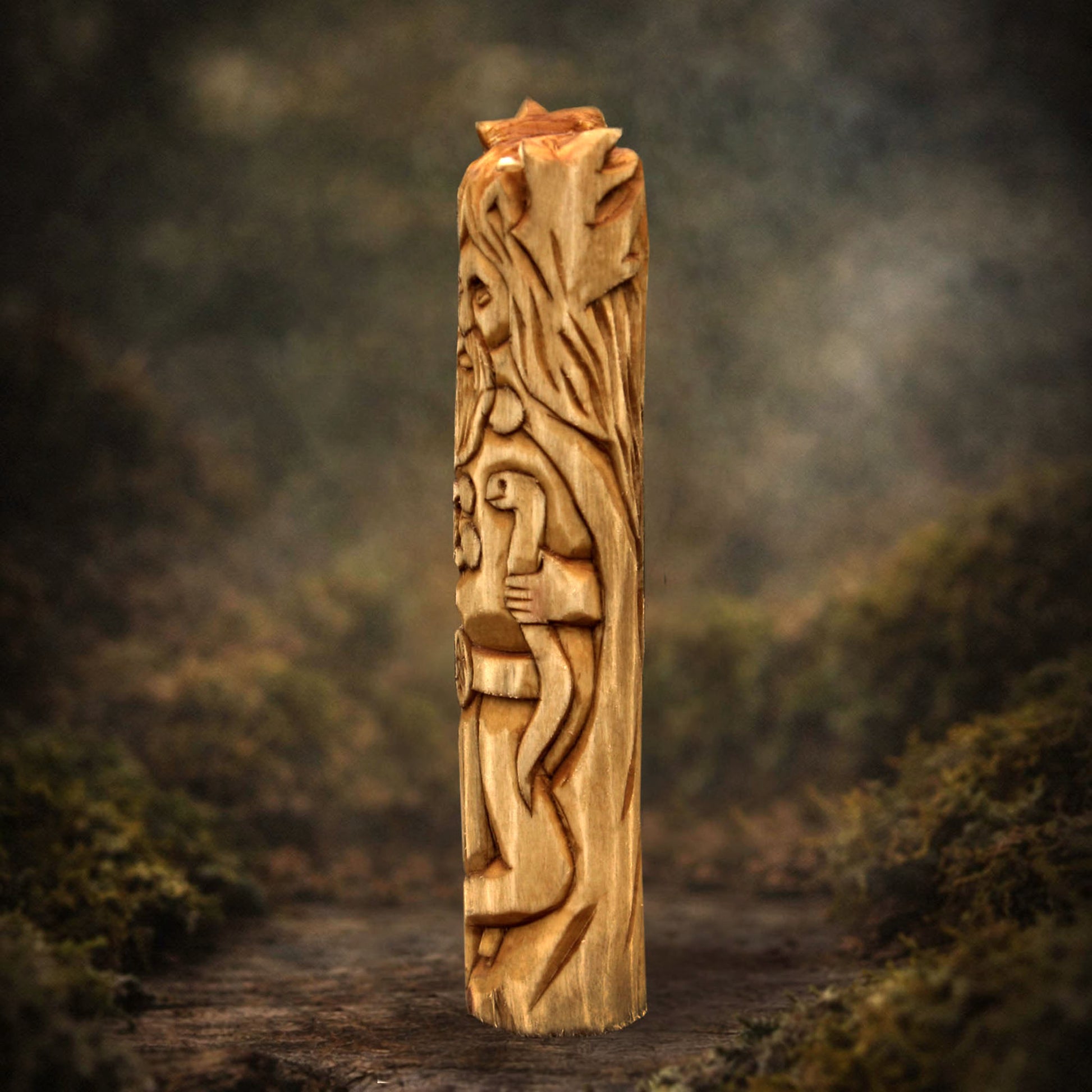 Side view of wooden Cernunnos figurine showing carving texture