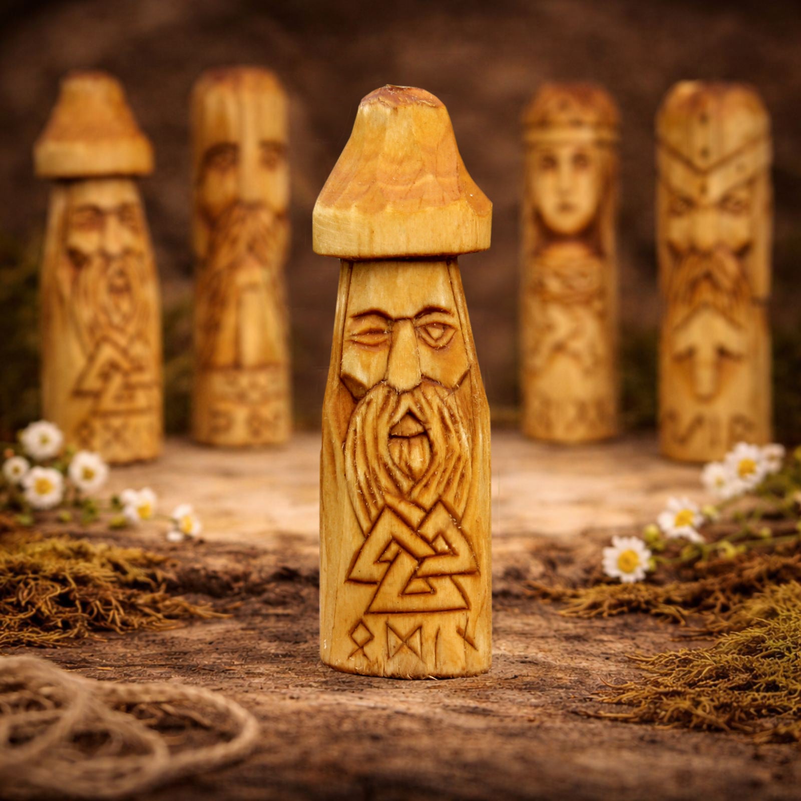 Wooden figurine Odin with carvings on a rustic background