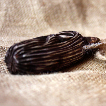 Hand-carved Slavic Veles amulet placed on altar natural wood talisman