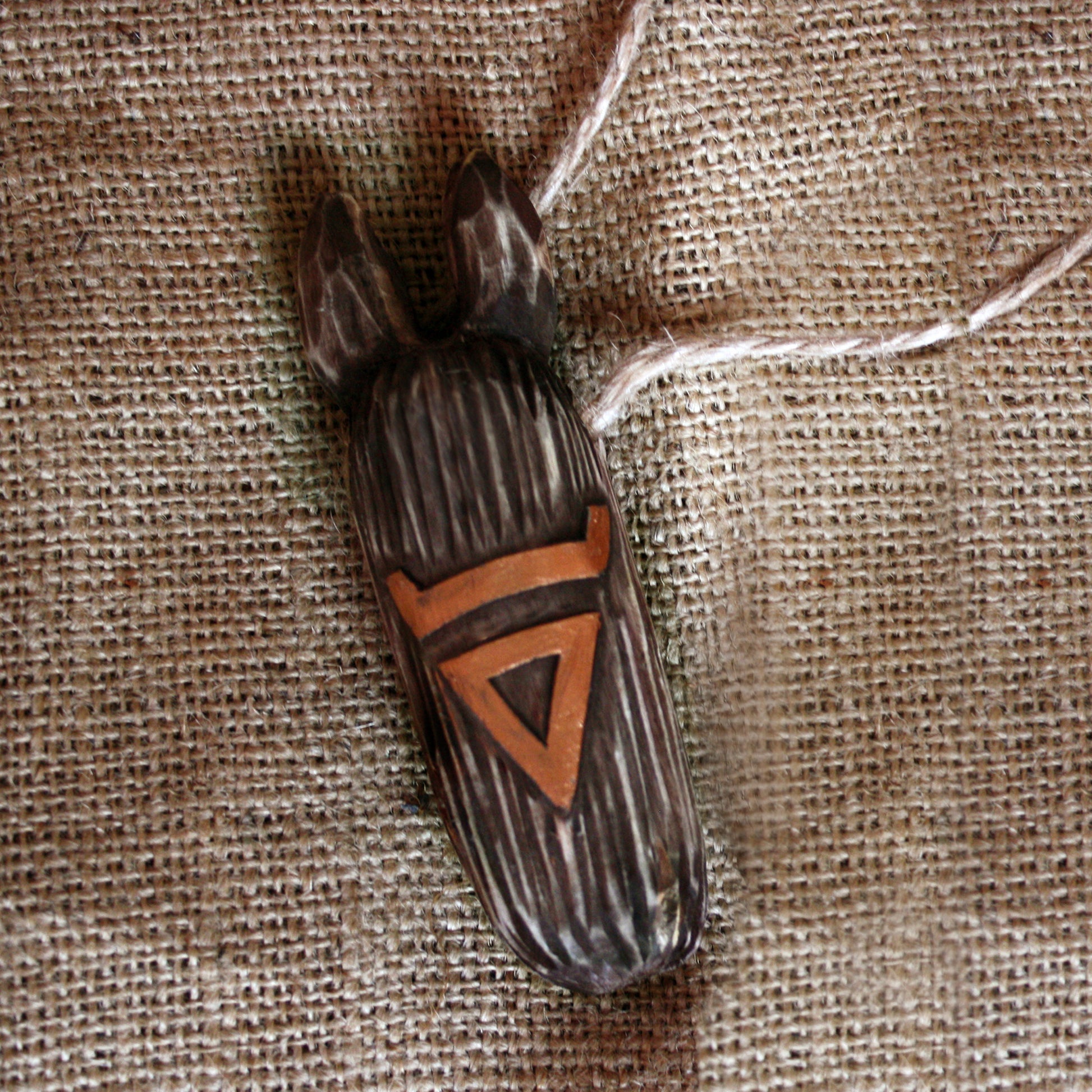Veles wooden amulet close-up hand-carved Slavic talisman natural wood texture