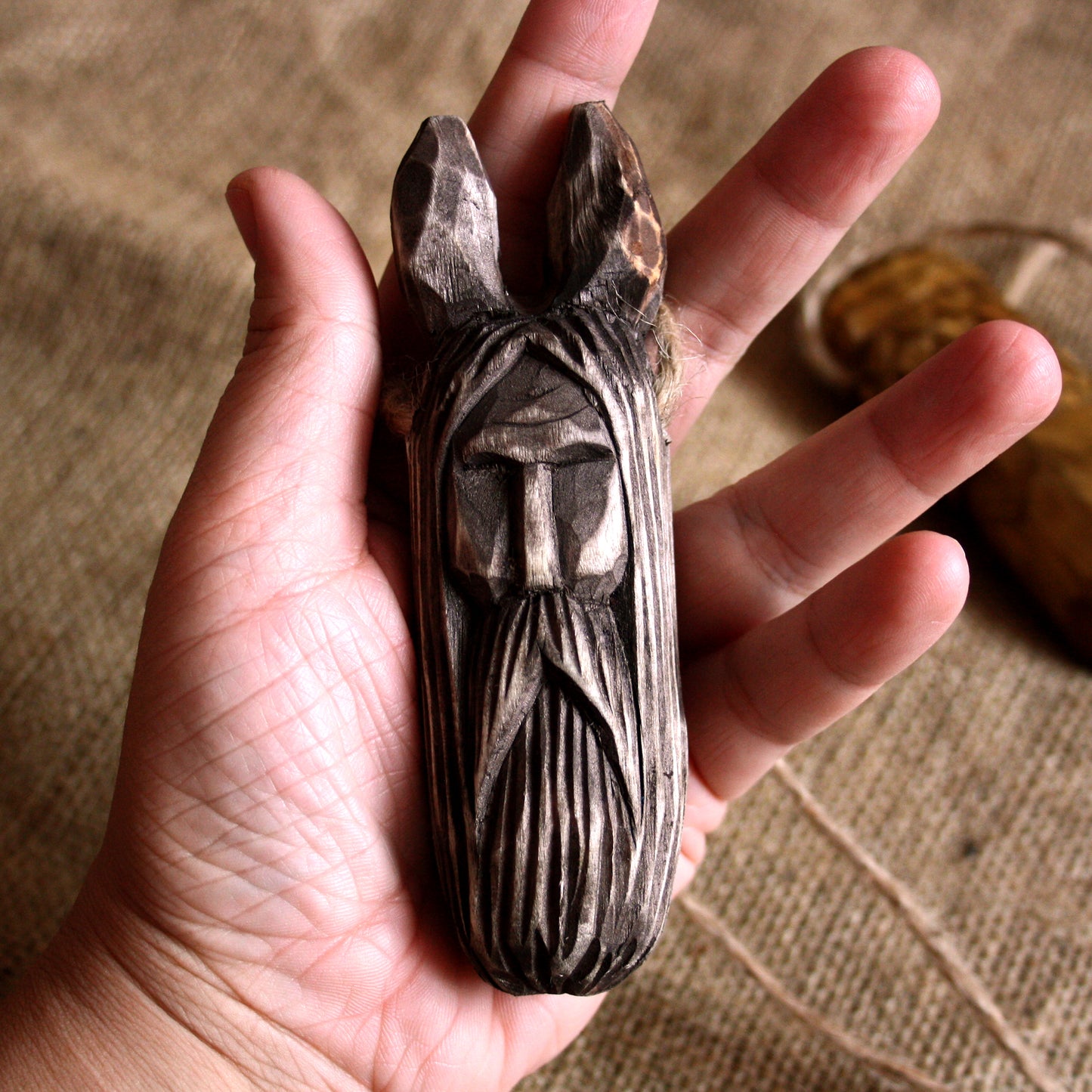 Veles wooden amulet held in hand showing size and craftsmanship