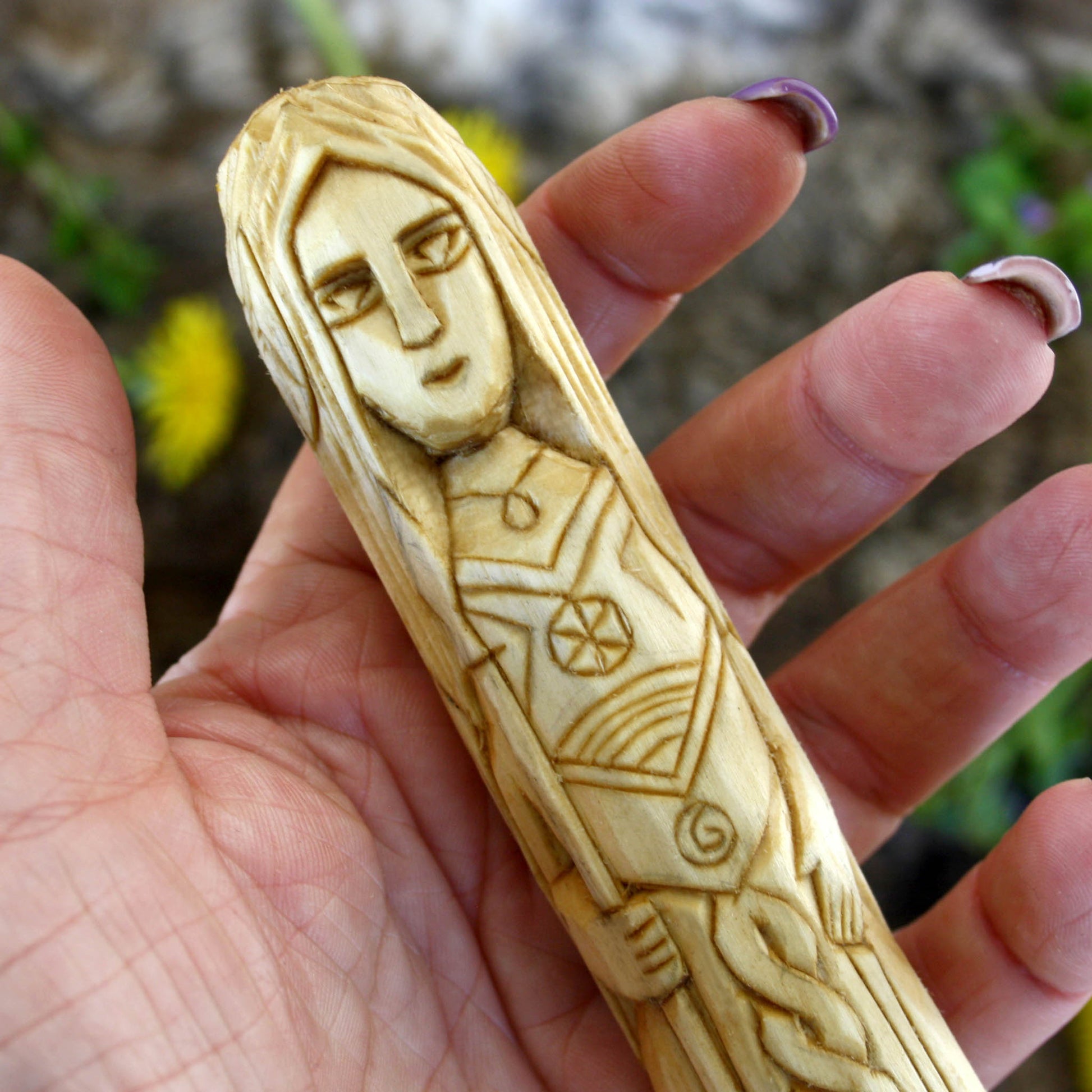 Close up Vor wooden statue face hand carved Norse goddess of awareness