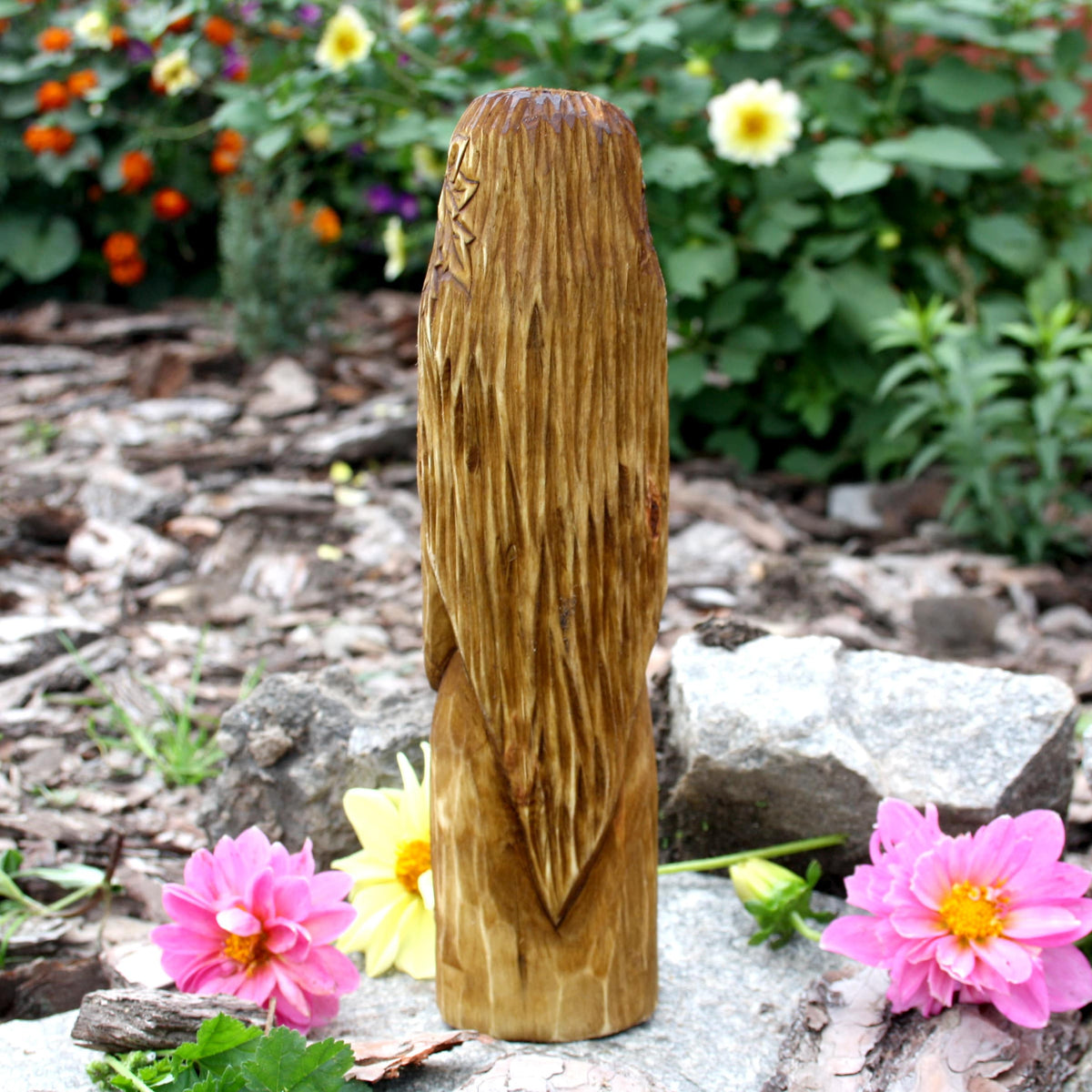 Back view of the hand-carved Áine statue showing the natural wood surface