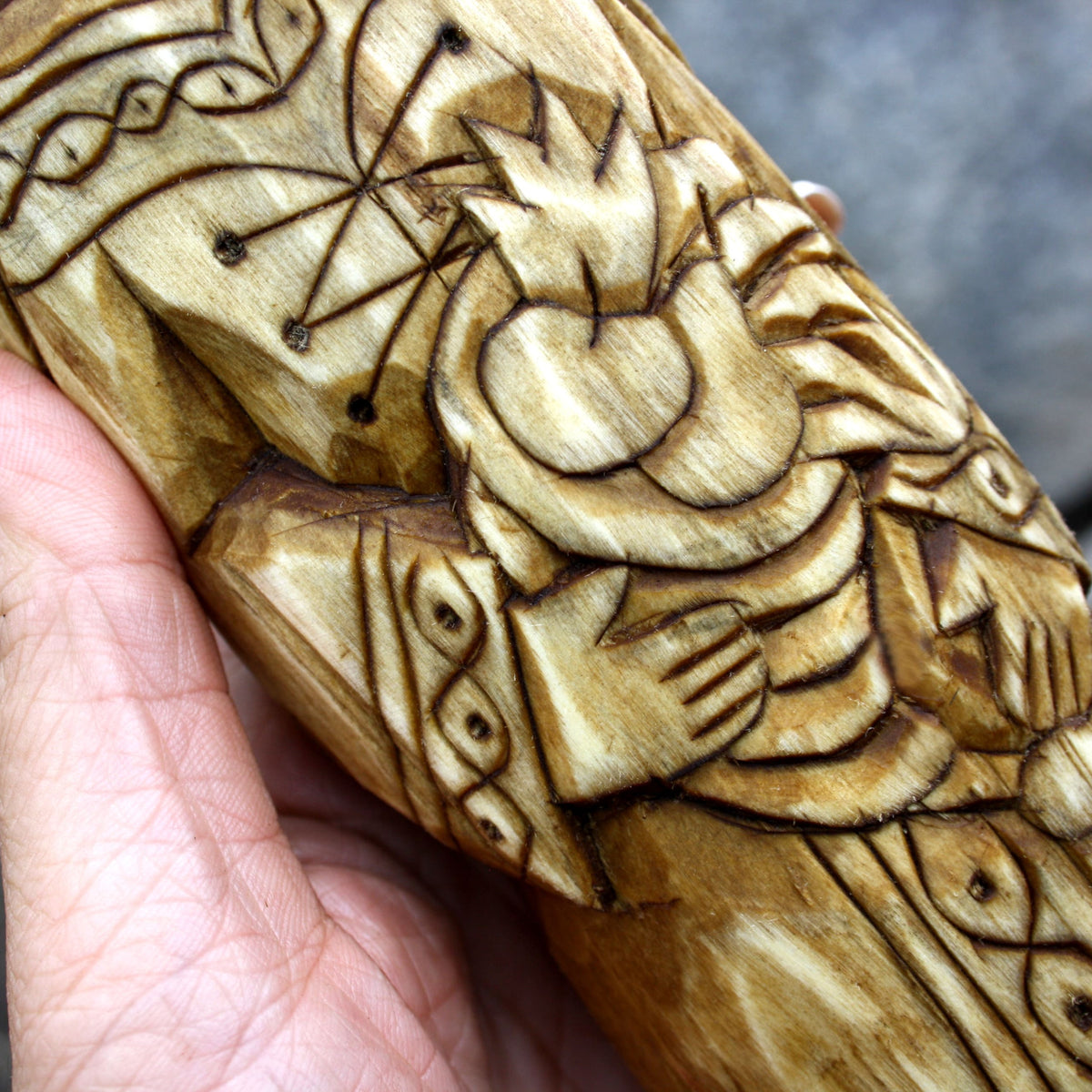 Detailed carved garment and decorative motifs on the Áine wooden sculpture