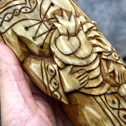 Detailed carved garment and decorative motifs on the Áine wooden sculpture