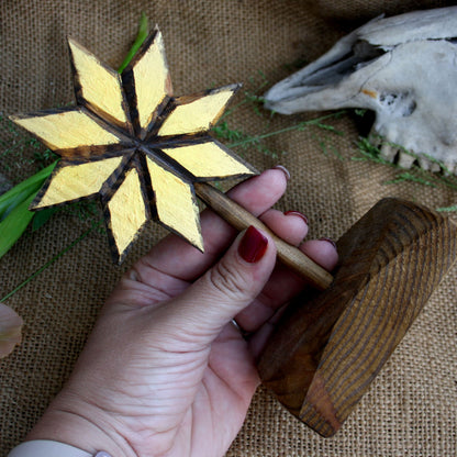 Wooden Alatyr Slavic symbol held in hand showing its size