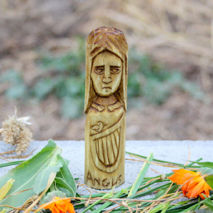 Hand-carved Angus wooden figurine inspired by the Irish deity associated with youth and love