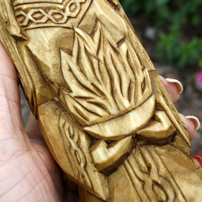 Detailed view of the carved garments and ornamental patterns on the Brigid statue