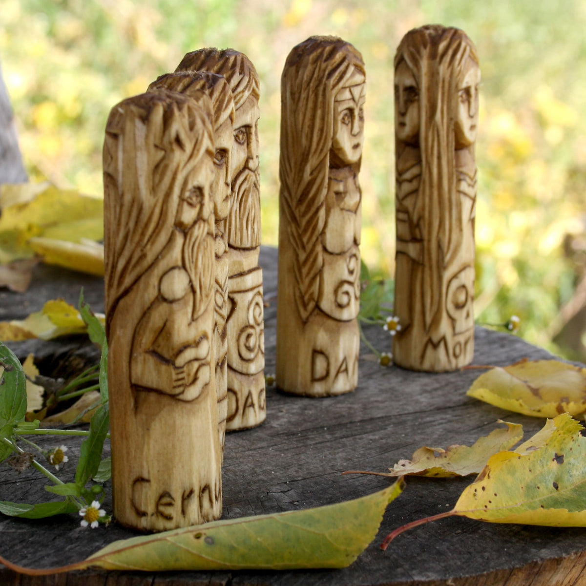 Side view of the Danu, Dagda, Brighid, Cernunnos and Morrigan wooden statue collection