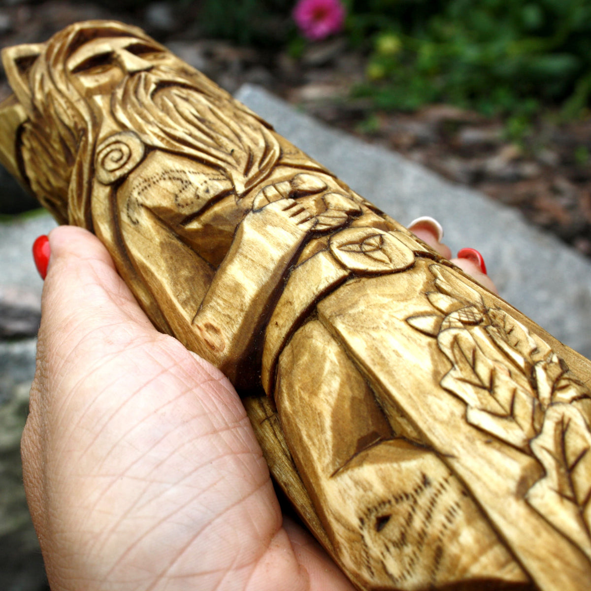 Close-up of the carved antlers, beard, and hair on the Cernunnos statue