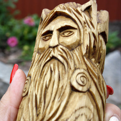 Close-up of Cernunnos with a detailed wooden face, beard, and horns
