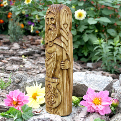 Profile of the Dagda sculpture with a long beard and carved decorative details