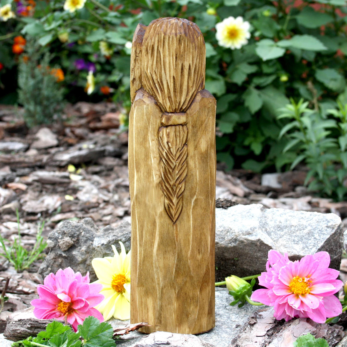 Back view of the hand-carved Dagda statue displaying the natural wood grain