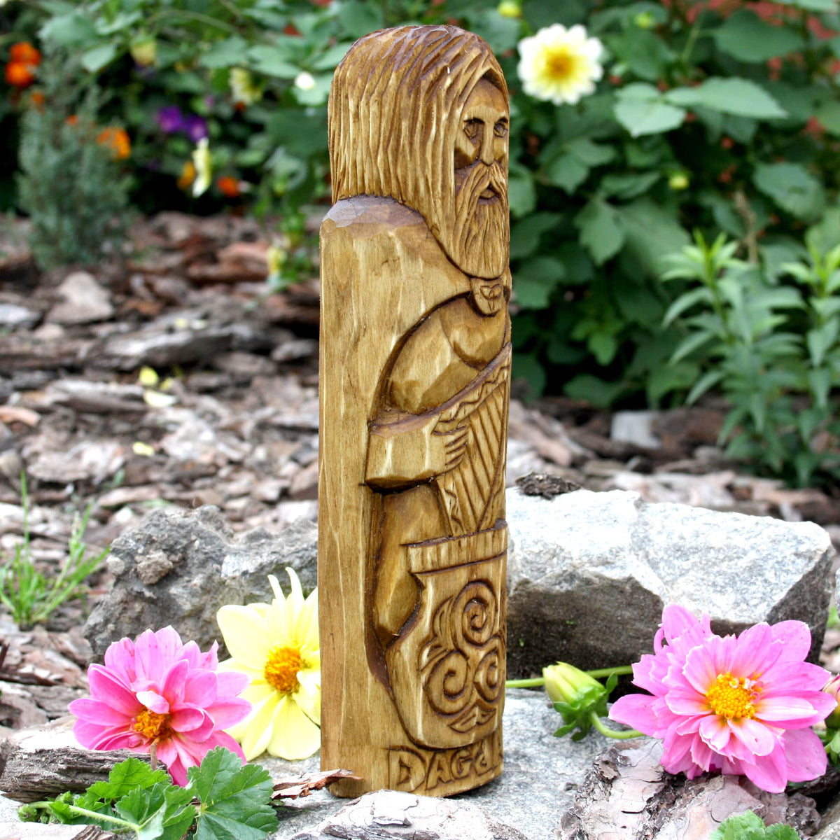 Side view of the Dagda wooden figure showing its carved hair and ornamental clothing
