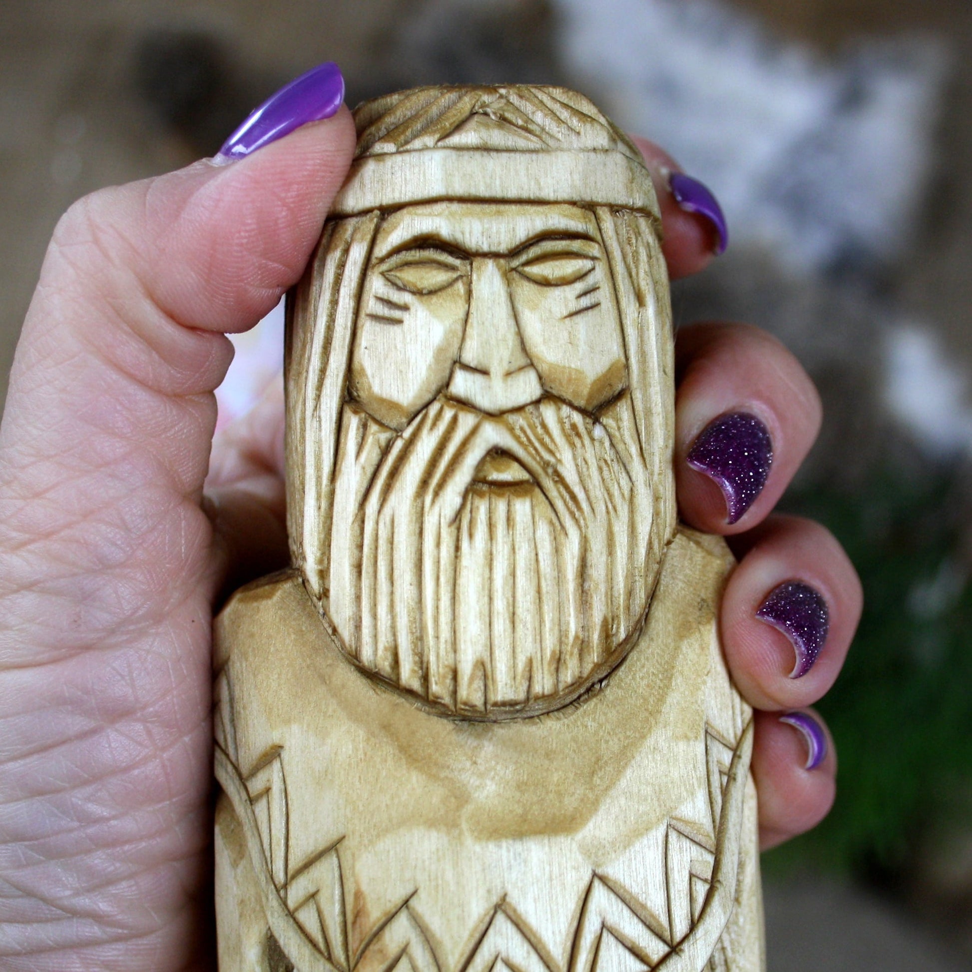 Close-up of Dazhbog Slavic God face hand carved wooden statue