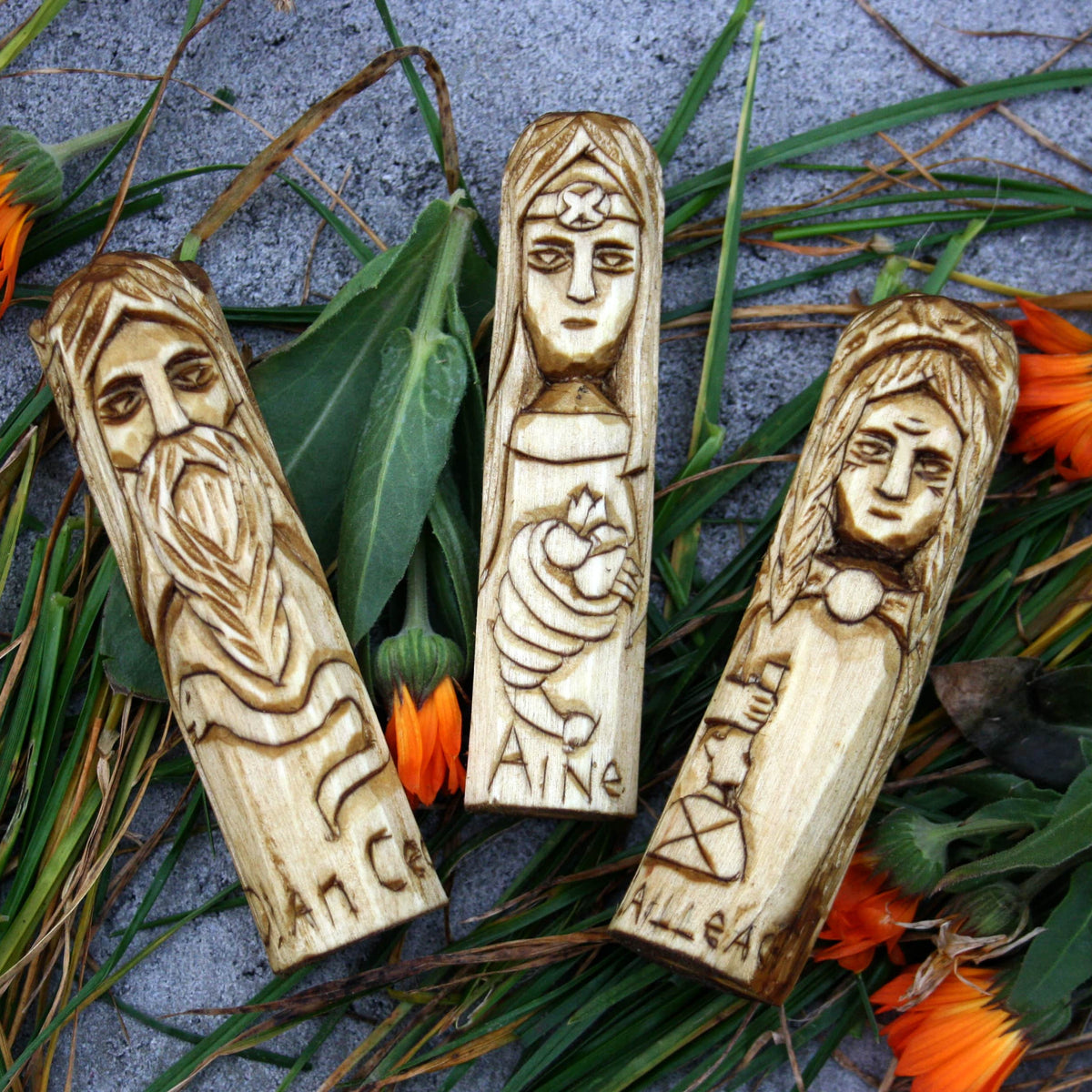 Three hand-carved 10 cm wooden Celtic figures of Dian Cecht, Áine and Cailleach
