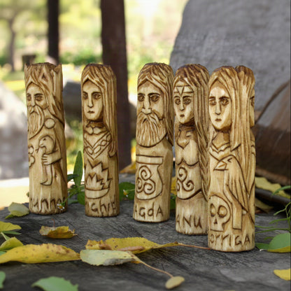 Angled view of five Celtic deity figurines carved from natural linden wood