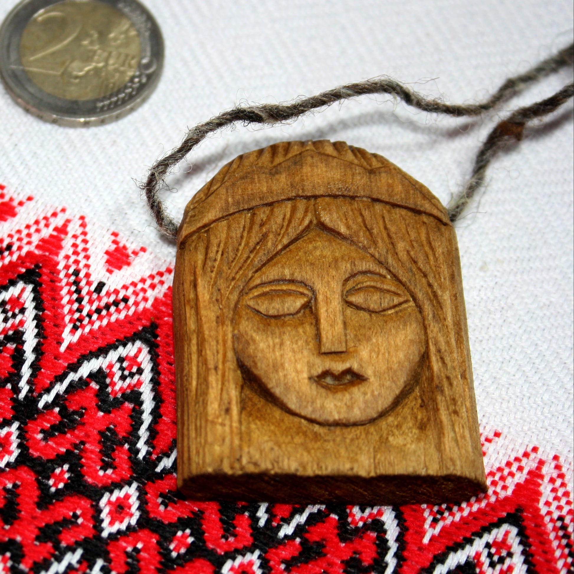 Front view of handmade Lada wooden pendant