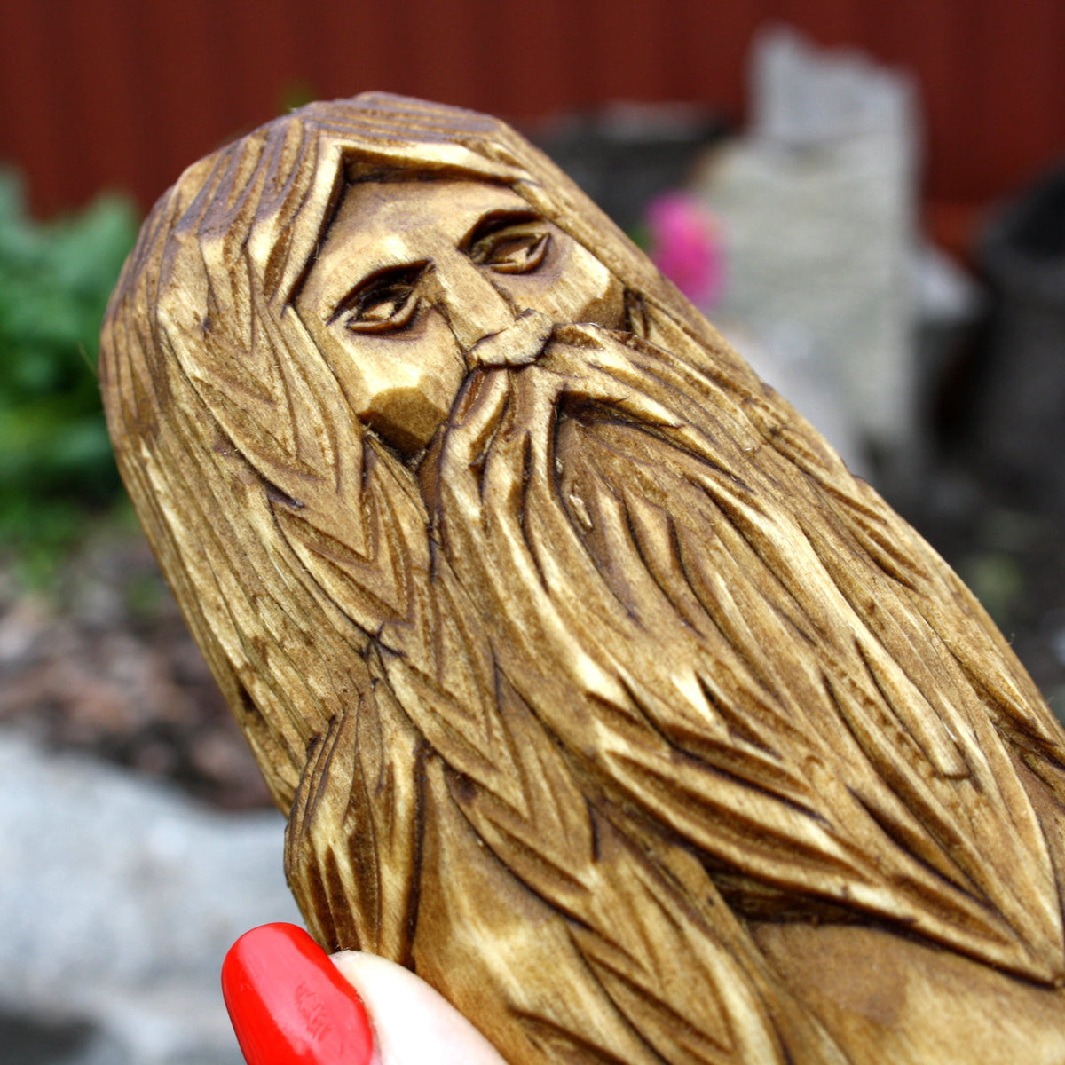 Close-up of Goibhniu's carved face and long textured beard
