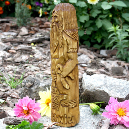 Side view of the Goibhniu statue highlighting its sculpted hair and ornamental details