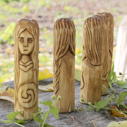 Rear view of the five-piece Celtic mythology figurine set showing the carved wooden details