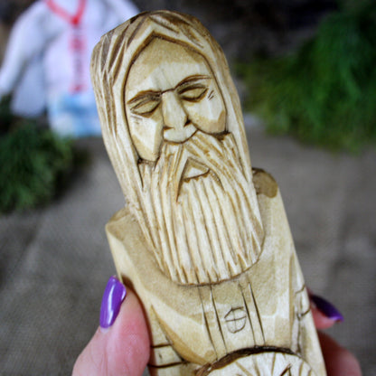 Close-up of Khors Slavic God face hand carved wooden statue