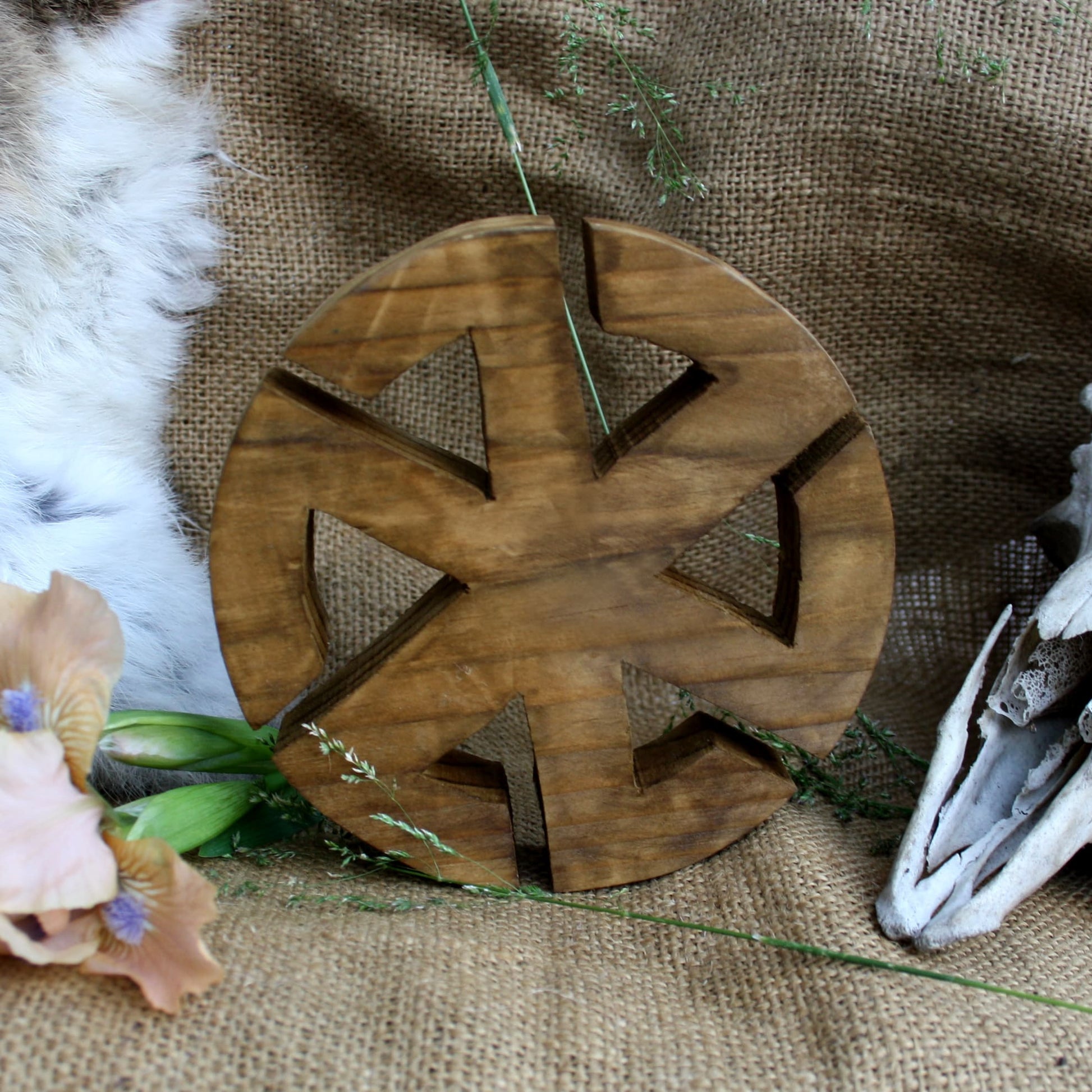 Back side of handcrafted wooden Kolovrat symbol made from natural linden wood