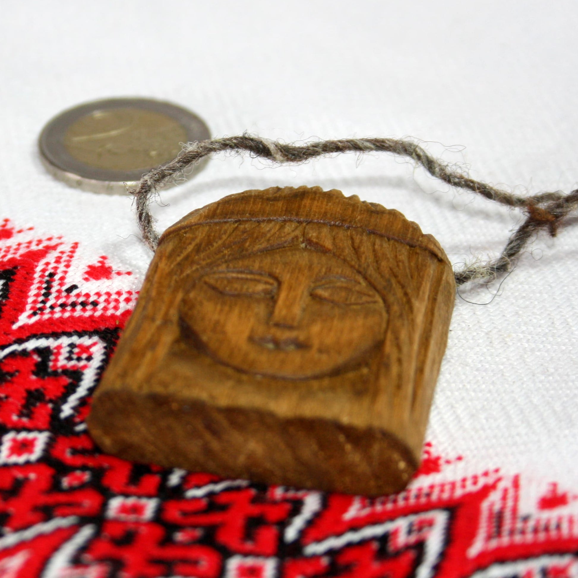 Side view of handmade Lada wooden pendant