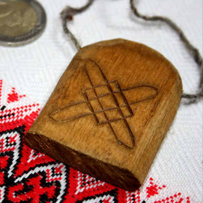 Back side of hand carved Lada pendant made from natural linden wood