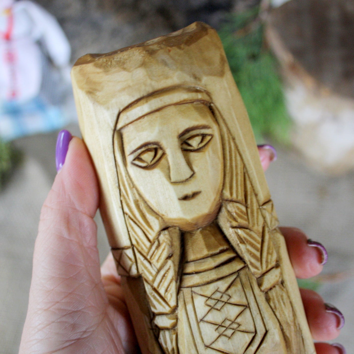 Close-up of Makosh Slavic Goddess face hand carved wooden statue