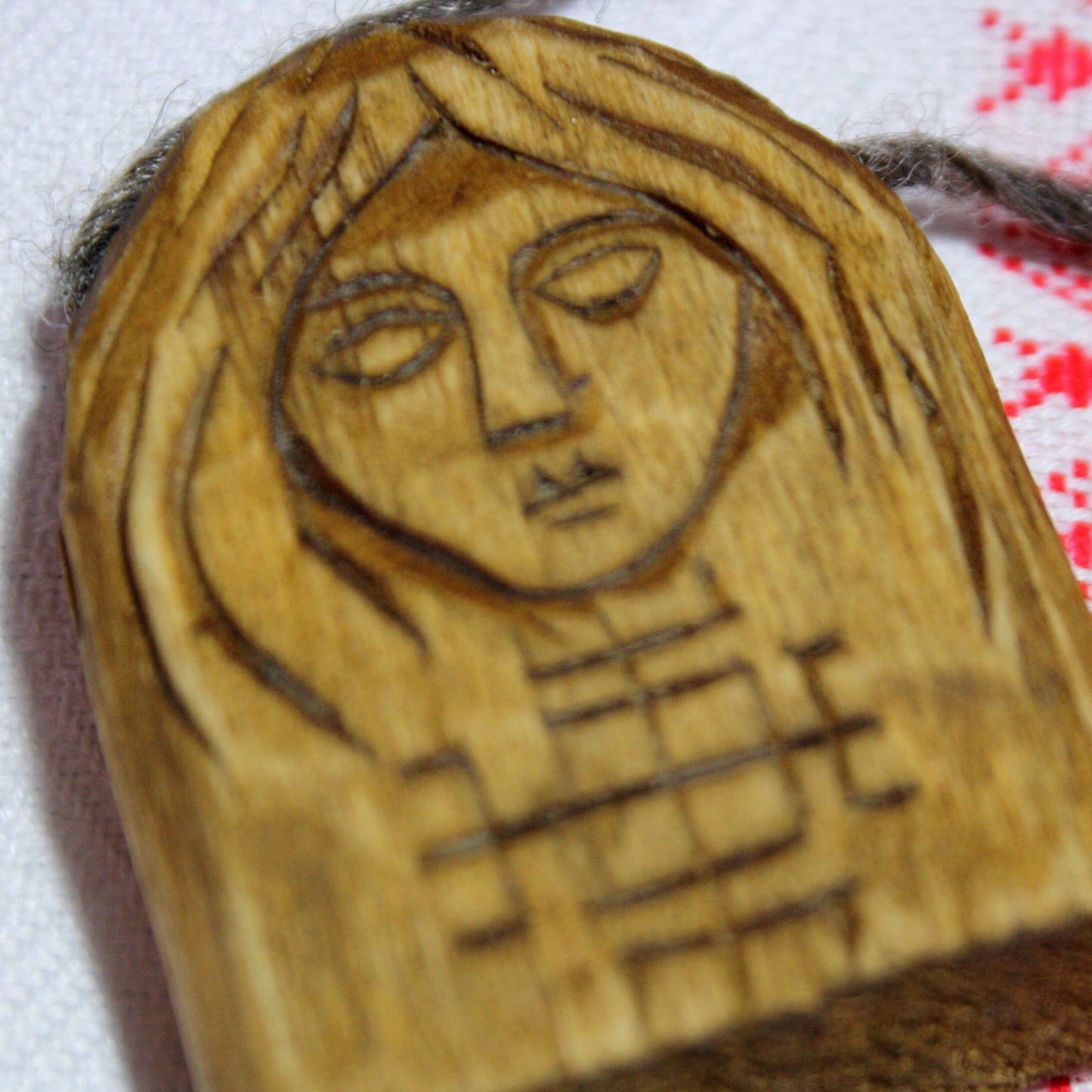 Front view of handmade Makosh wooden pendant