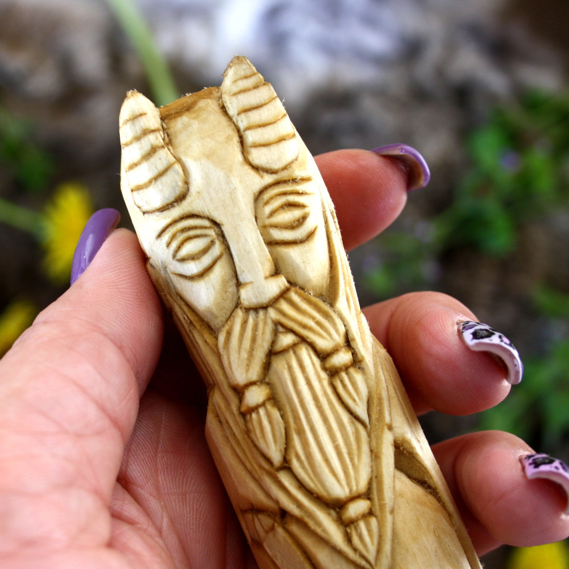 Close up Mimir wooden statue face hand carved Norse guardian of wisdom