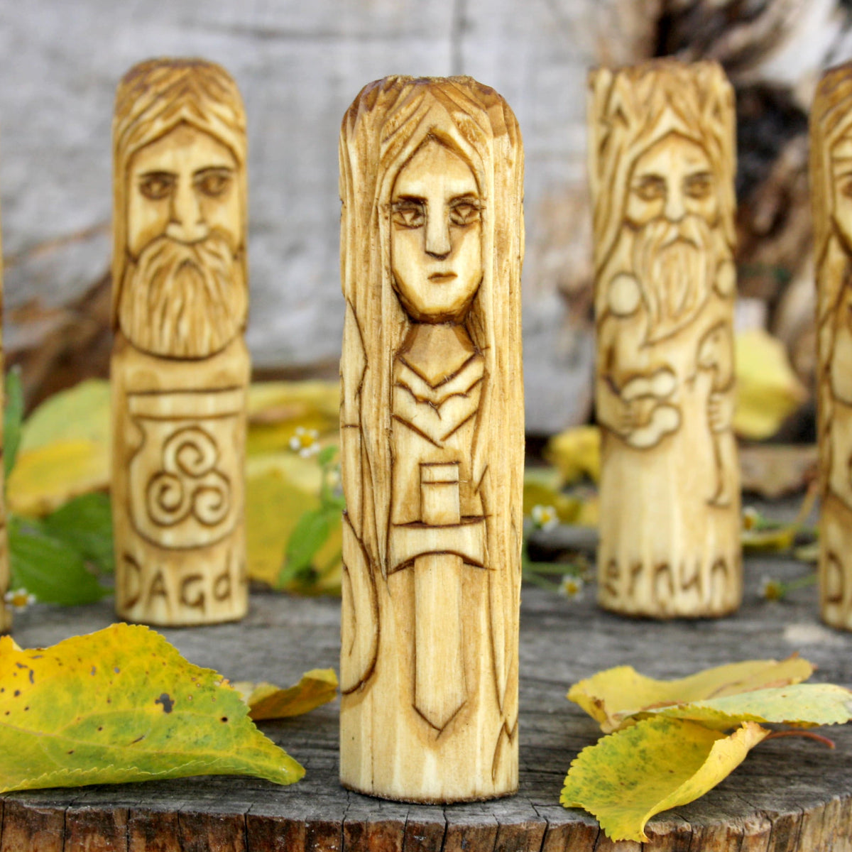 Third view of the hand-carved Morrigan figure showing its distinctive alternate face