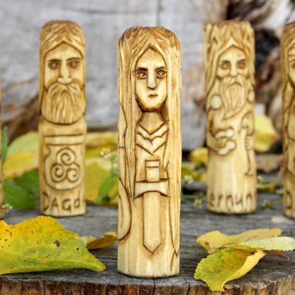Third view of the hand-carved Morrigan figure showing its distinctive alternate face