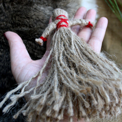 Hand holding Ukrainian Motanka Doll showing its size