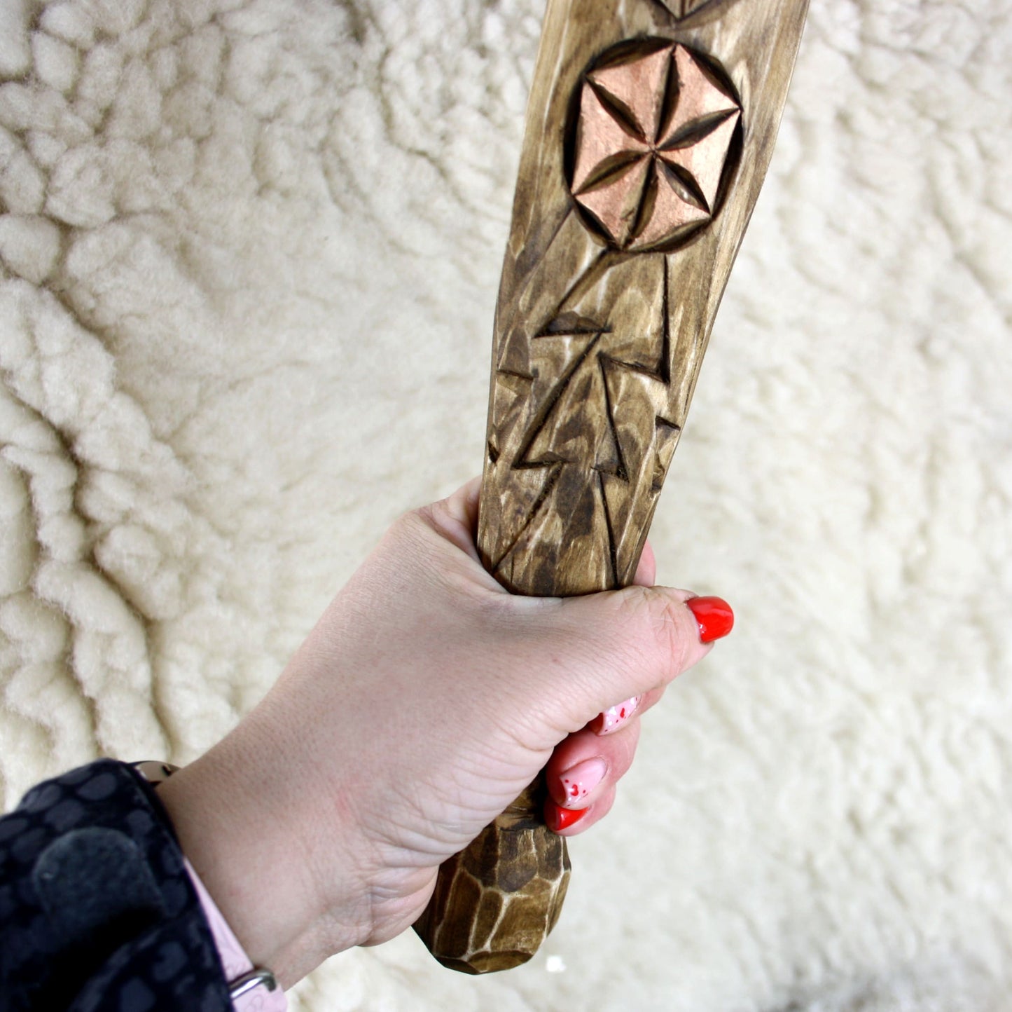 Close-up of carved Kolovrat symbol on Perun staff