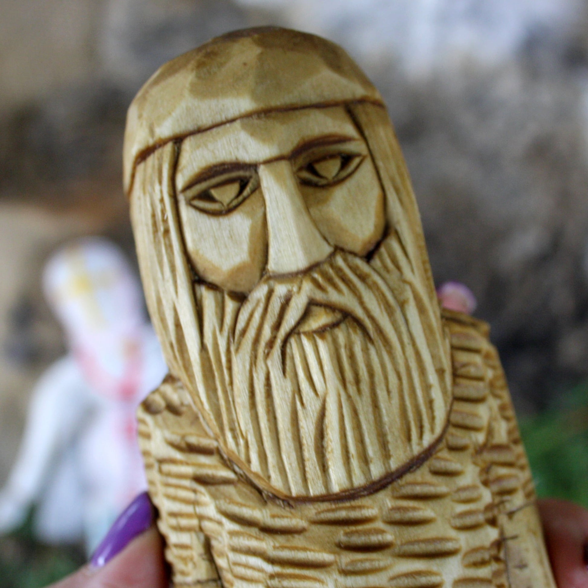 Close-up of Perun Slavic God face hand carved wooden statue