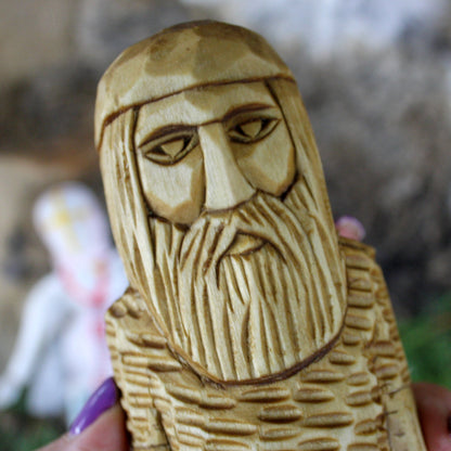 Close-up of Perun Slavic God face hand carved wooden statue