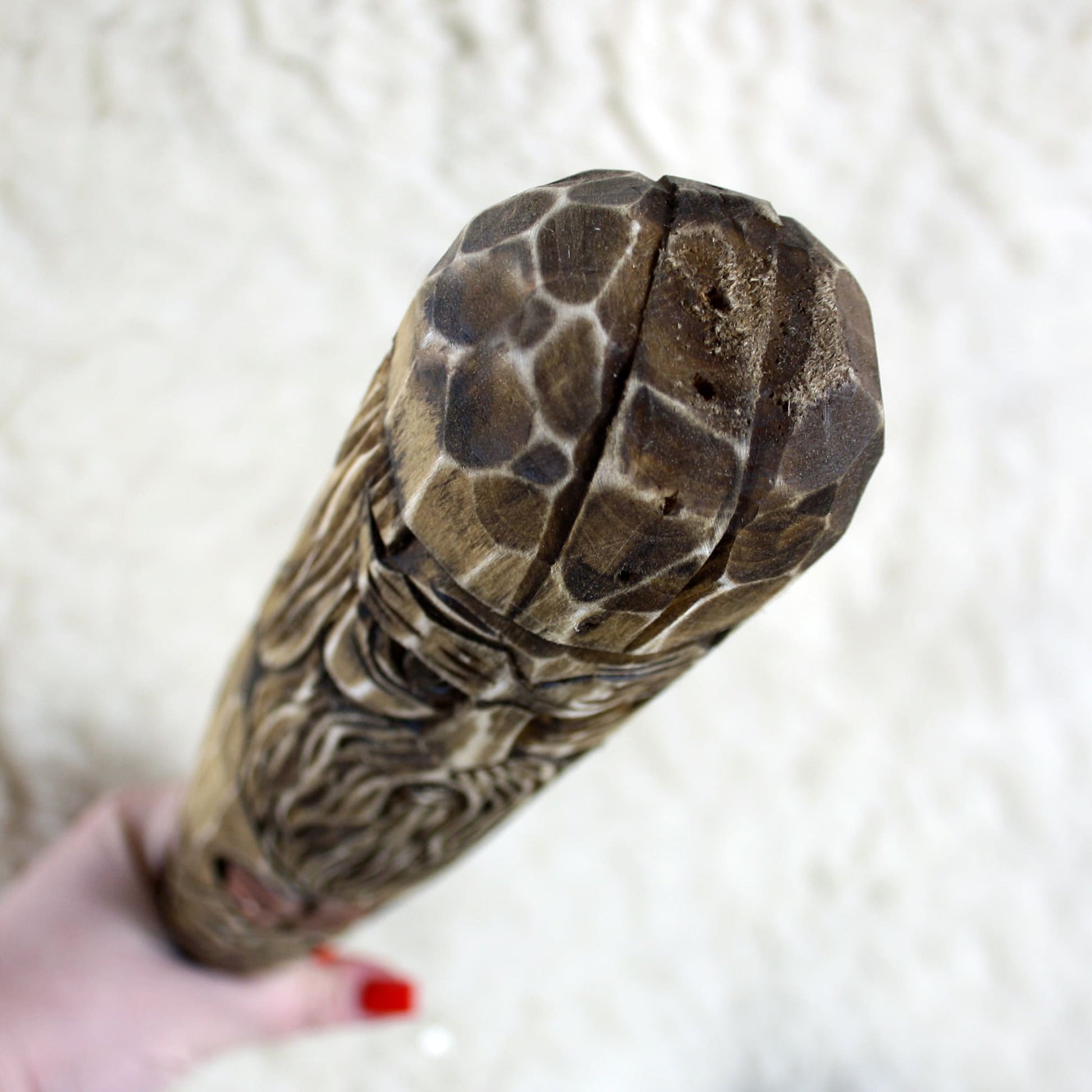 Top view of hand carved Perun wooden walking stick