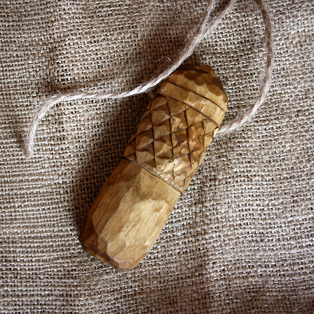 Back view of hand carved Perun wooden amulet