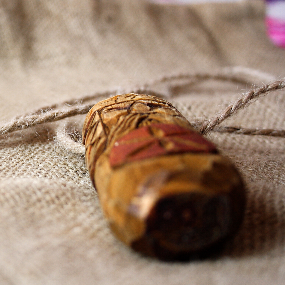 Side profile of handmade Perun wooden pendant