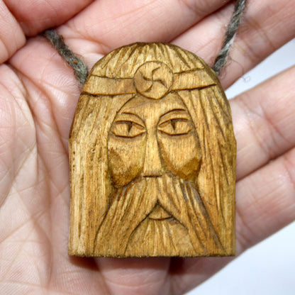 Rod wooden pendant shown in hand for size comparison